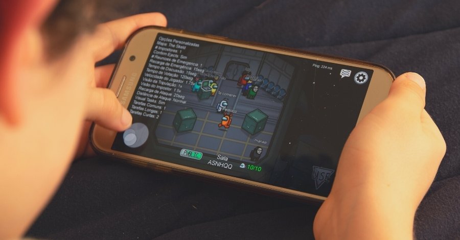 tween playing among us on a cell phone