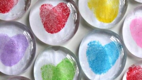 Rainbow thumbprint heart magnets on glass stones