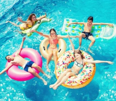 Kids floating in a pool on giant floaties