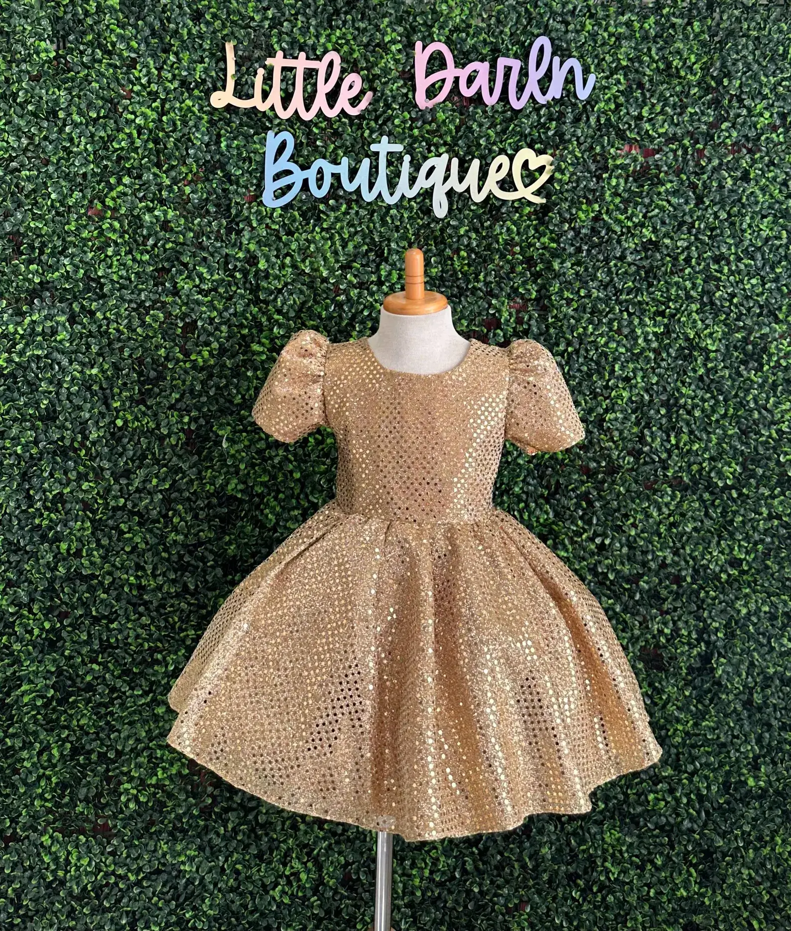 Gold sequin cap sleeve Christmas dress for tweens with a sparkly puff-sleeve bodice and full twirl skirt, displayed on a mannequin.
